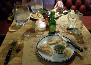 Table filled with contemporary food and drink.