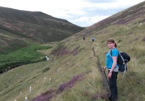 Nikki standing on a path on a hillside.