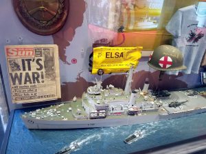 Some memorabilia from the Falklands conflict including the front page of the Sun newspaper "It's War!"