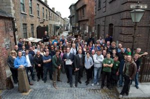 The entire cast of Ripper Street, standing in an old fashioned street in Ireland.