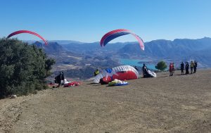 Paragliders launching from high in the mountains