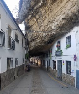 Some houses on each side with a rock "roof"