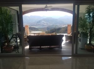 View throug living room showing mountains and a reservoir 