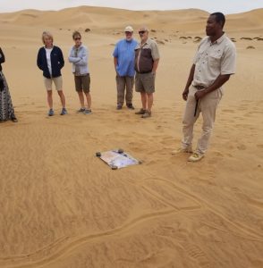 Our guide with a map of Namibia drawn in the sand