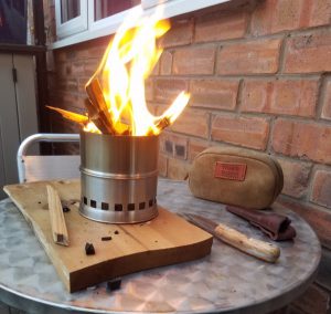 A lit camping stove, that burns sticks.